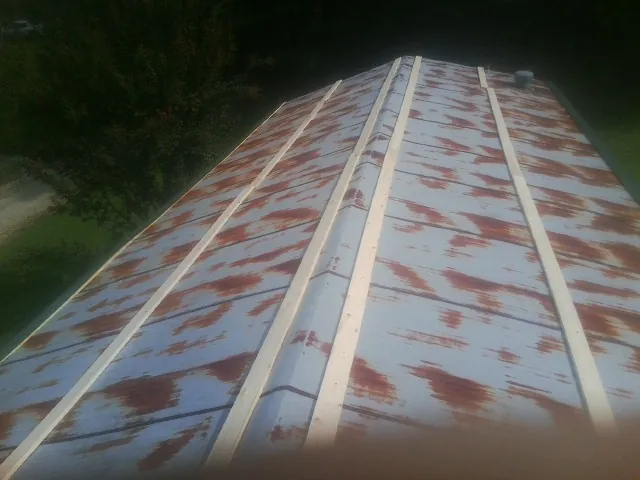 Rusted metal roof panels with new wood purlins before replacement — Storm Damage Roof Repair in Mayodan by Roofing Brothers